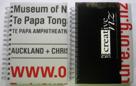 Recycled poster notebooks made from a Creative New Zealand campaign